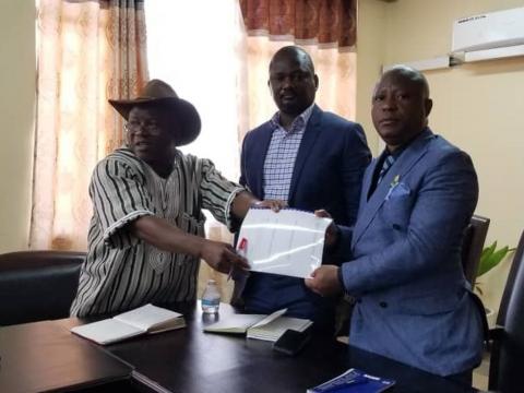 Abu Brima of NMJD presents the document to Minister Rado Yoki