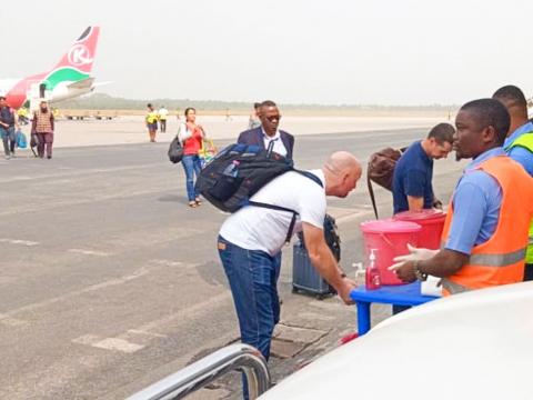 Airport officials screen passengers at Lungi International Airport