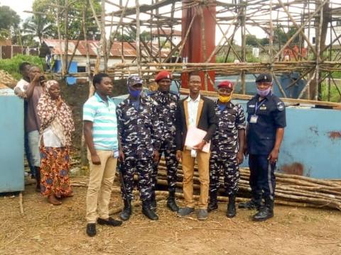 Albert Yarhah, Southern Regional Manager for PRA at the construction site with security personnel