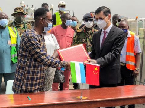Chinese official handing over the Covid vaccines