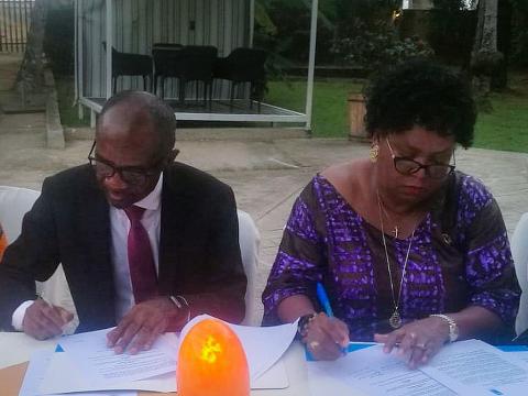 UNDP boss and the MRU Secretary General signing the MOU