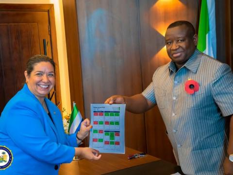 Amb Brewer presenting MCC Scorecard to President Bio