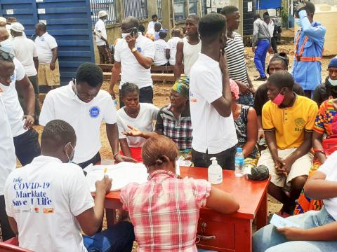 Volunteers take Covid-19 jabs during launch of the mass vaccination campaign in Tombo